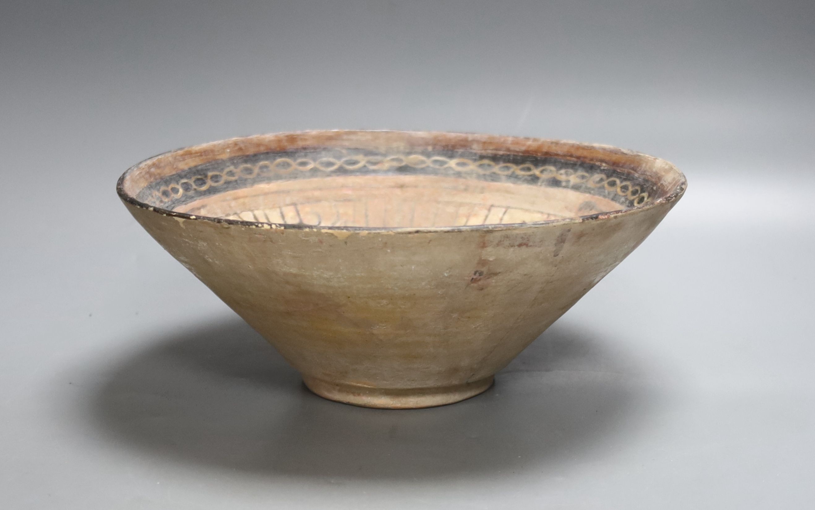 An Islamic bowl with kufic script, diameter 24cm
